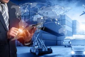 Double exposure image of businessman holding a tablet and world map logistic network.