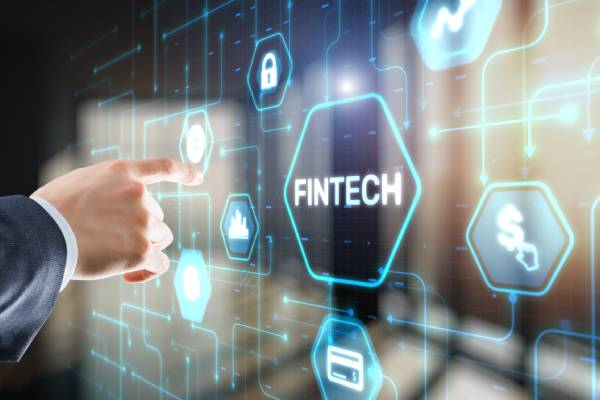 Image of a hand pointing at the Fintech icon on a virtual screen.