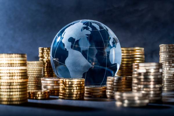 Heap of coins with a globe in the middle indicating global banking.